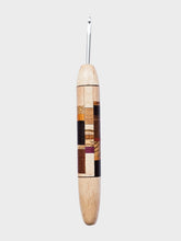 Wooden crochet hook with a patterned handle on a WHITE background