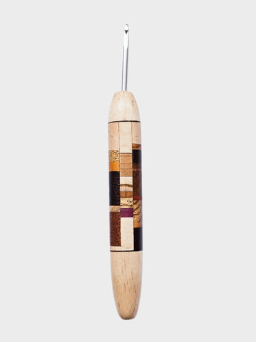 Wooden crochet hook with a patterned handle on a WHITE background