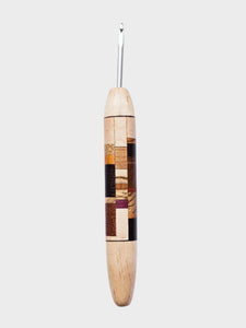 Wooden crochet hook with a patterned handle on a WHITE background