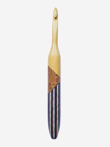 Crochet hook with wooden handle and black and blue striped shaft on white background