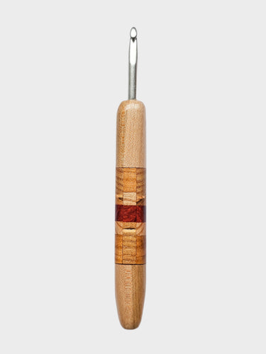 Wooden-handled crochet hook on a light gray background