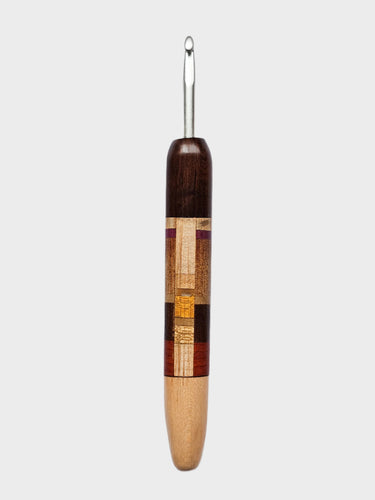 Wooden-handled crochet hook on a gray background