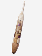 Wooden crochet hook with a striped pattern on a white background