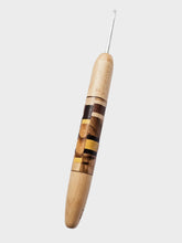 Wooden crochet hook with a white background