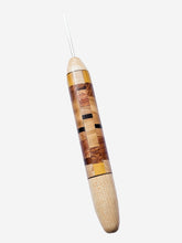 Wooden crochet hook with a checkered pattern on a white background