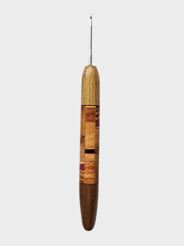 Wooden-handled crochet hook on a gray background