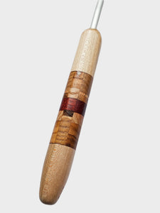 Wooden tool handle with a silver tip on a light gray background