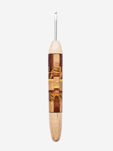 Wooden crochet hook with metal end on a light gray background