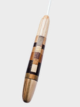Wooden Crochet hook with a checkered pattern on a white background