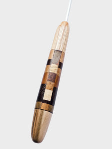 Wooden Crochet hook with a checkered pattern on a white background