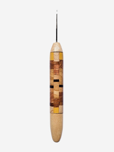 Wooden crochet hook with a multicolored handle on a light gray background