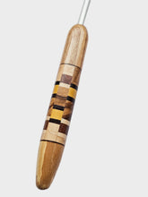 Wooden handle with a silver tip on a light gray background