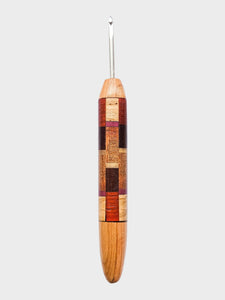 Wooden crochet hook with a patterned handle on a white background