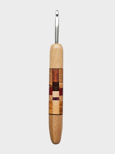 Wooden-handled crochet hook on a gray background