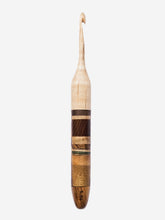 Wooden crochet hook with a striped design on a white background
