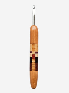 Wooden crochet hook with a checkered pattern on a white background