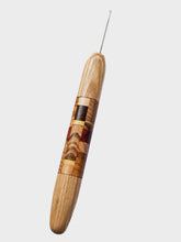 Wooden-handled needle on a light gray background
