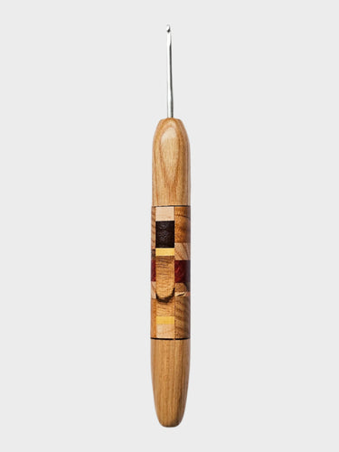 Wooden crochet hook on a light gray background