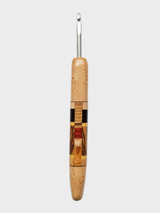 Wooden-handled crochet hook on a gray background